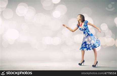 Woman in dress. Young woman in blue dress against bokeh background