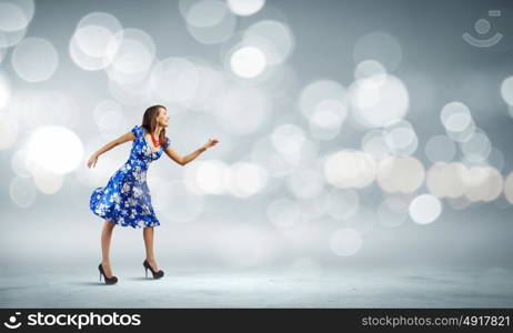 Woman in dress. Young woman in blue dress against bokeh background