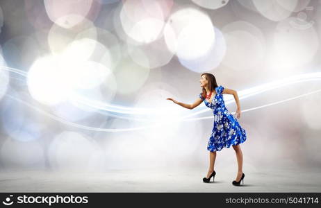 Woman in dress. Young woman in blue dress against bokeh background