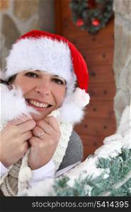 Woman in festive hat stood with decorations