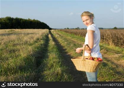 Woman in field with basket