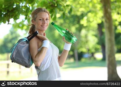 woman in fitness clothes drinking