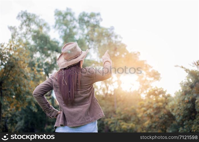 Woman in forest with the sunlight at sky in summer.