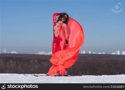 Woman in frd dress on ski with flag