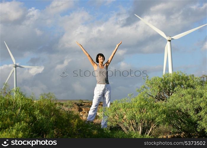 Woman in front of a wind farm