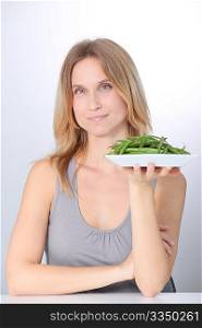 Woman in front of plate of green beans