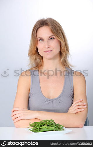 Woman in front of plate of green beans