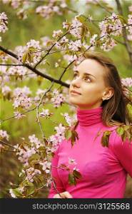 Woman in front of sakura spring blossoms