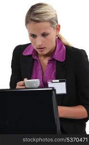 Woman in front of the computer with a cup of coffee