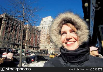 Woman in fur hooded jacket smiling