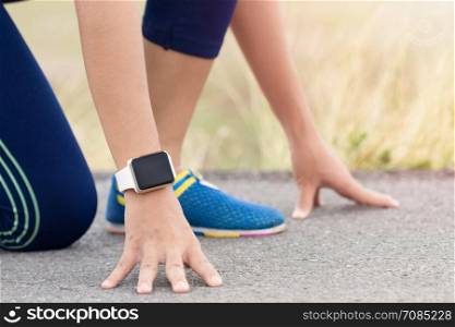 woman in gesture ready to run on road during evening