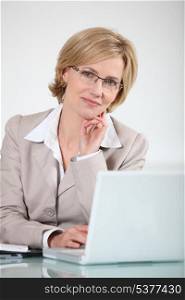 Woman in glasses at laptop computer
