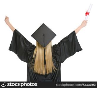 Woman in graduation gown rejoicing success . rear view