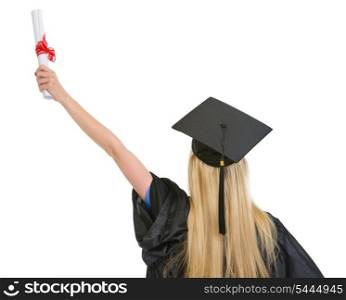 Woman in graduation gown with diploma rejoicing success . rear view