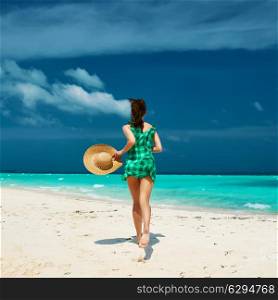 Woman in green dress at tropical beach