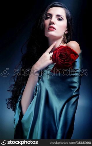 woman in green fabric with red rose