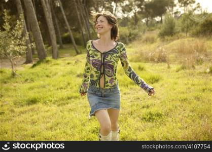 Woman in green outdoor running and smiling happy