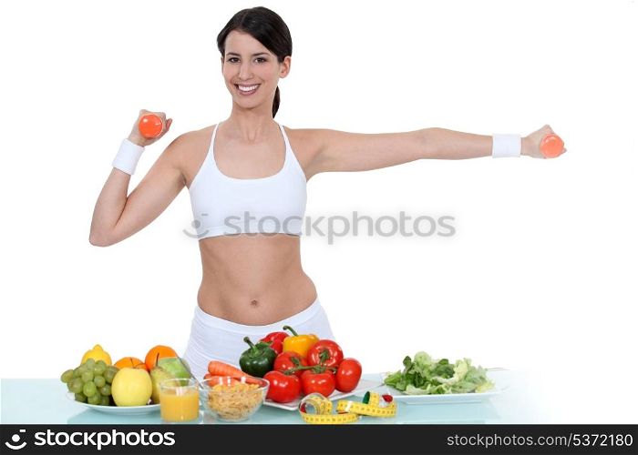 Woman in gym-wear stood with vegetables