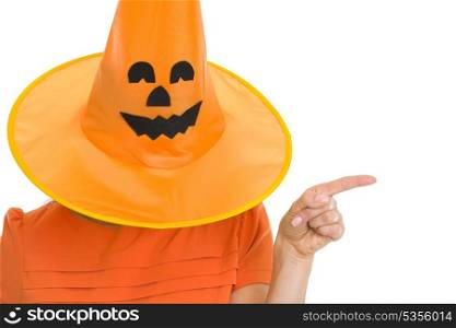 Woman in Halloween hat over head pointing on copy space