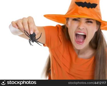 Woman in Halloween hat scaring with spider