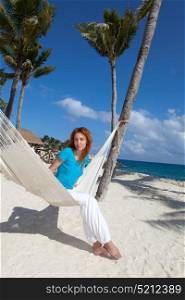 woman in hammock on background of ocean and sky