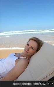 Woman in hammock on the edge of the beach