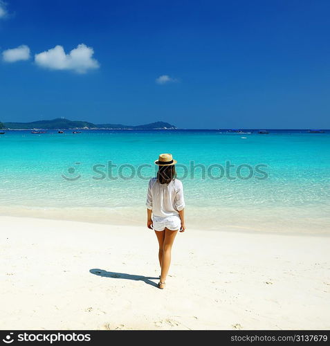 Woman in hat at beach