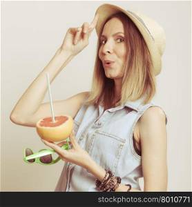 Woman in hat drinking grapefruit juice. Diet. Woman tourist in straw hat drinking grapefruit juice and holding sunglasses. Healthy diet food. Weight loss. Summer vacation holidays.