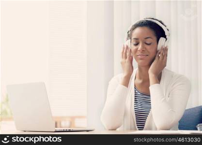 Woman in headphones sitting at desk in office