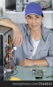 woman in her 50s fixing a computer