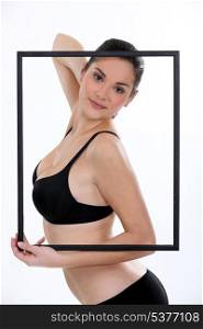 Woman in her underwear posing in a picture frame