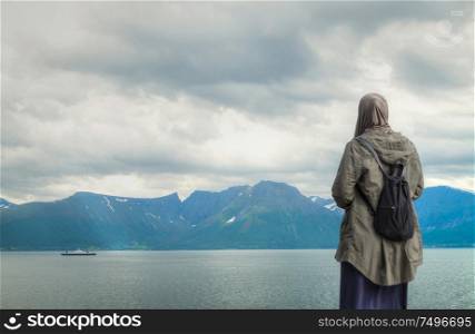 Woman in hijab against the background of the Norwegian fjords