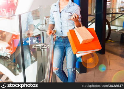 Woman in jeans clothing holding shopping bags, Fashion and Lifes. Woman in jeans clothing holding shopping bags, Fashion and Lifestyle concept