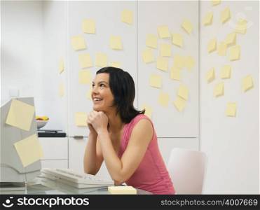 Woman in kitchen with adhesive notes