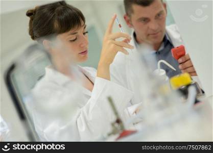 woman in lab and colleague in the background