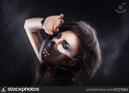 woman in leather mask and water spray