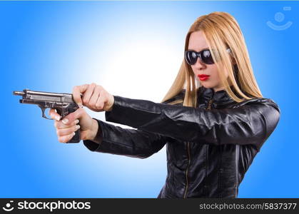 Woman in leather suit with handgun