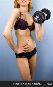 Woman in lingerie working out with dumbbell