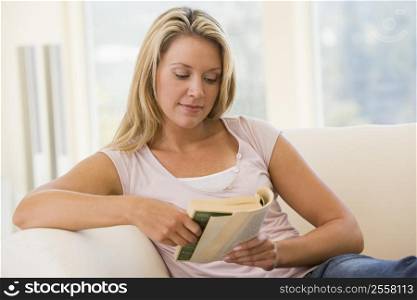 Woman in living room reading book