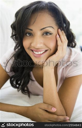Woman in living room smiling (high key/selective focus)
