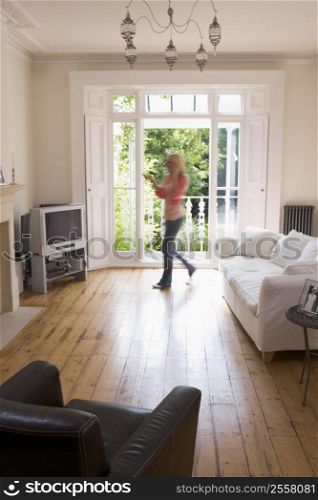 Woman in living room talking on telephone