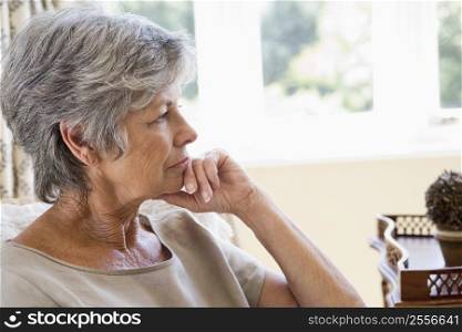Woman in living room thinking