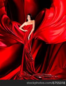 woman in long red dress on red fabric