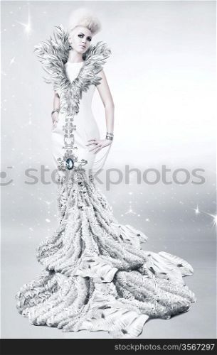 woman in long white dress with feather collar