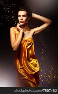 woman in long yellow dress and jewelry