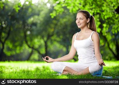 Woman in lotus pose in the park