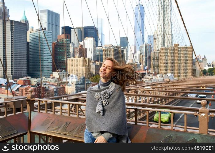 Woman in New York City with Manhattan skyline at background