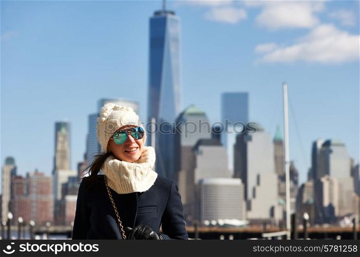 Woman in New York City with Manhattan skyline at background