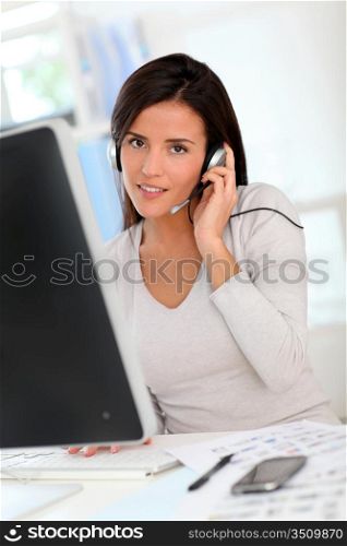 Woman in office having a video conference with business partners