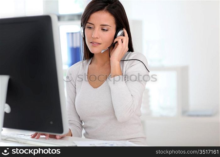 Woman in office having a video conference with business partners
